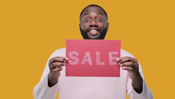 Amazed Young Black Man Guy Hold Banner with SALE Title on Yellow Background alt
