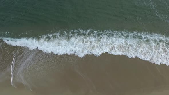 Aerial Drone View of Tropical Beach Ocean Waves Reaching Shore alt