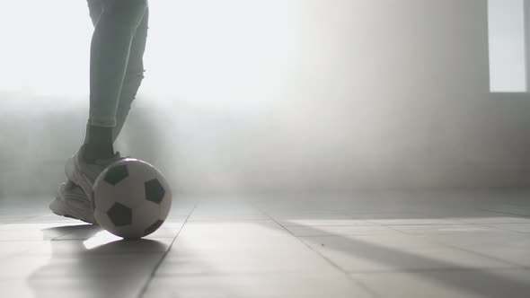 Closeup Football Dribbling in Slow Motion in an Underground Parking Lot in Sunlight alt