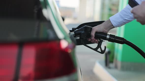 Unrecognizable Businessman Refueling Car from Gas Station