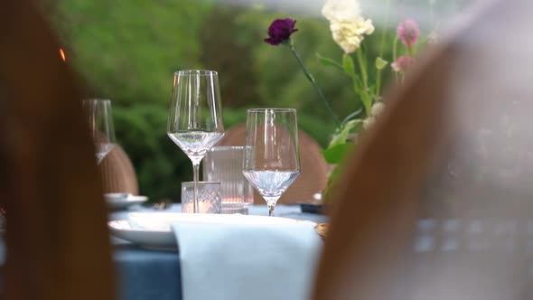 Slider shot of drink glasses on a dinner table outside for a garden wedding or event alt