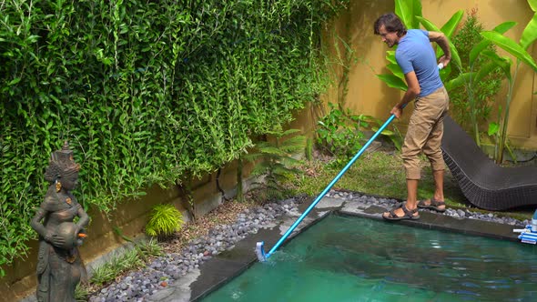 Young Man Professional Swimming Pool Cleaner Does Pool Cleaning Service