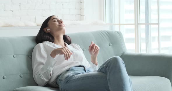 A Beautiful Girl Listens to Relaxing Music on Her Phone and Gets Excited By the Pleasant Vibes alt