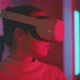 Young woman looking around and smiling wearing vr goggles in pink neon light - VideoHive Item for Sale