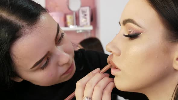 A Special Matte Lip Liner is Applied to the Lips of the Model alt