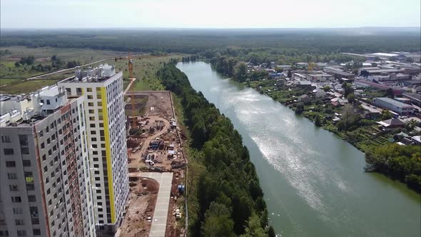 Bird's Eye View Of Modern Multi-storey Buildings Almost Completed with Bright Facades Next To the alt