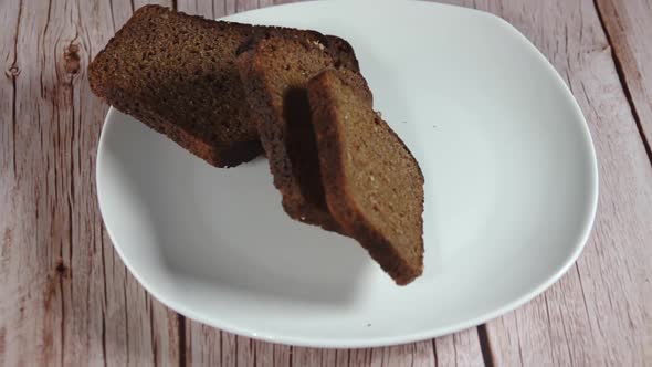 Slices of Rye Bread Fall on a White Plate