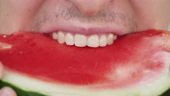 Closeup Hungry Caucasian Man Appetizingly Bite a Juicy Watermelon