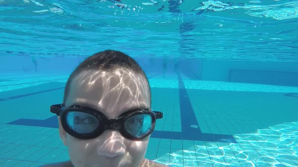 Boy Plunges Into the Pool