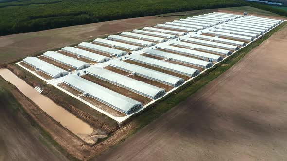 Modern production plant on the field. White buildings of innovative factory on nature background. alt