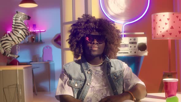 Trendy Black Guy in Bright Colored Neon Room alt