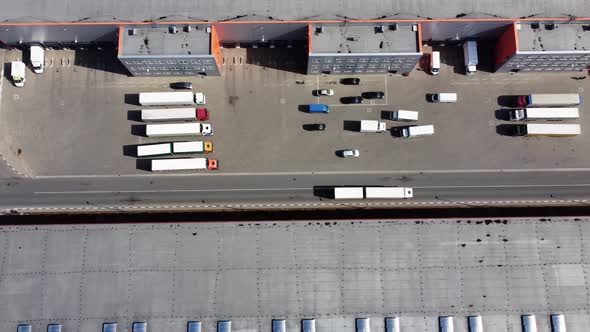 The white truck drives through the territory of the logistics center alt