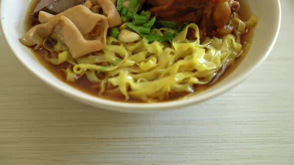 egg noodles with stewed and braised duck in brown soup - Asian food style alt