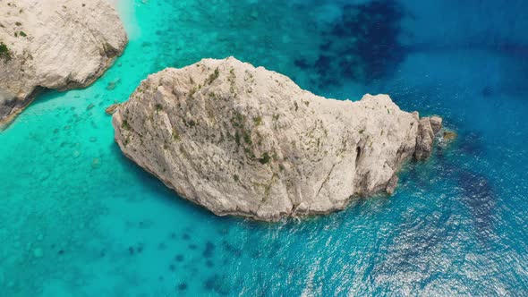 Aerial view of scenic coastline with cliff and aqua blue sea. alt