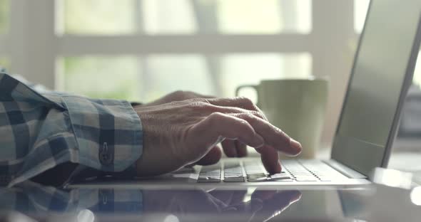 Man sitting at desk and working with a laptop