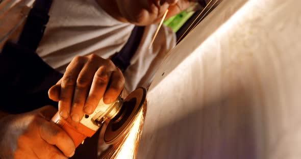 Male Mechanic Using Grinder Machine in Garage 4k alt