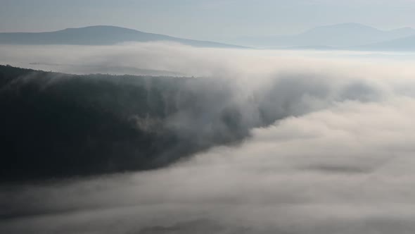 Scenic Timelapse of Cloud River Drifting in a Mountain Valley in the Morning alt