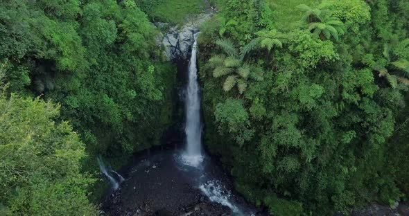 Aerial view from drone flying over Kedung Kayang waterfall and all surrounding vegetation in Central alt