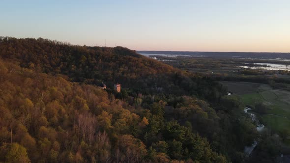 Aerial view around mountain overseeing Mississippi River and sunset, then back around to see shrine.