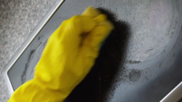 Vertical Shot Woman Hand in Yellow Rubber Gloves Washes Induction Stove Using Spray Detergent