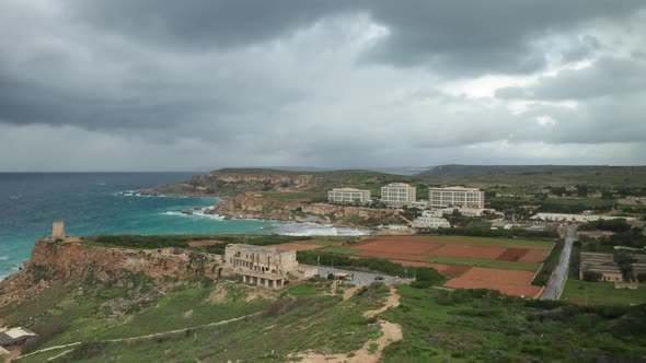 AERIAL: Ghajn Tuffieha Bay with Thick Black Storm Clouds Forming Over Horizon