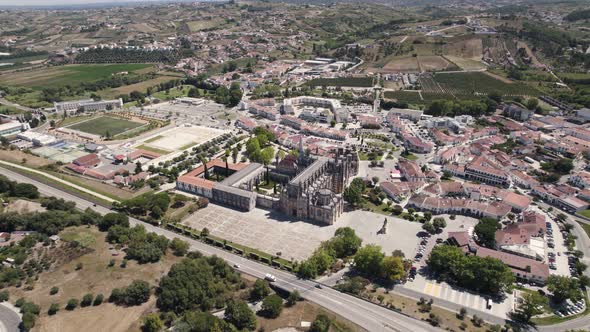 Aerial backwards view of the monastery of Batalha, with its surrounding wide area. Portugal alt
