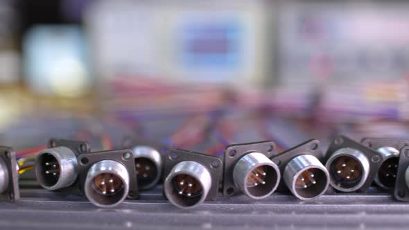 Slider Shot Video of Blurry Metal Sockets for Plugs