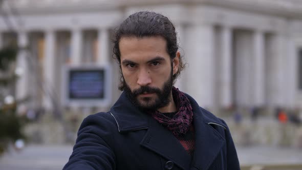 Serious young man  Making No Hand Sign with Finger in the city.Forbidden gesture alt