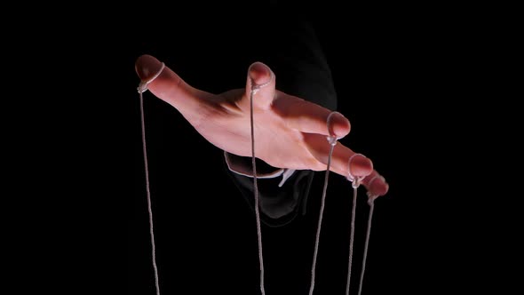 Hand Of Dictator In A Business Suit With Strings On The Fingers To 