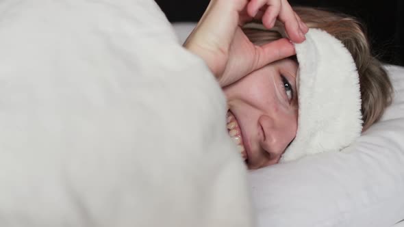 Happy Smiling Woman With Sleeping Mask Looking At Camera And Going To Sleep