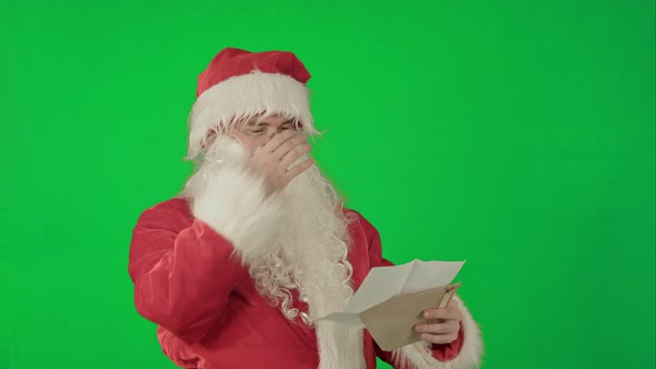 Santa Claus Reading Letters From Children on a Green Screen Chrome Key alt