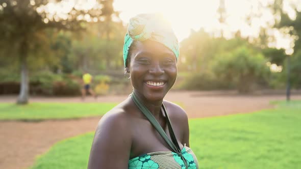 Portrait of happy African woman wearing colorful traditional turban