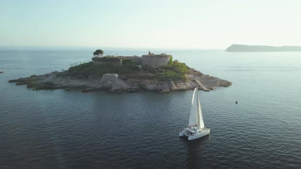 Aerial view of Yacht cruising on the sea or ocean in summer day in Montenegro. alt