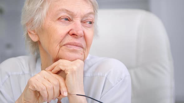 Thoughtful wise aged lady with sad eyes wrinkly face alt
