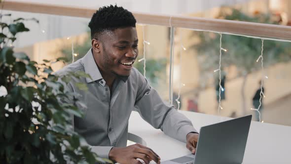 Young Joyful Man Communicating Via Video Call on Laptop Talking Supports Motivates to Friend Remote alt