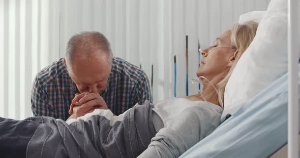 Upset Senior Man Visiting Wife in Coma in Hospital alt