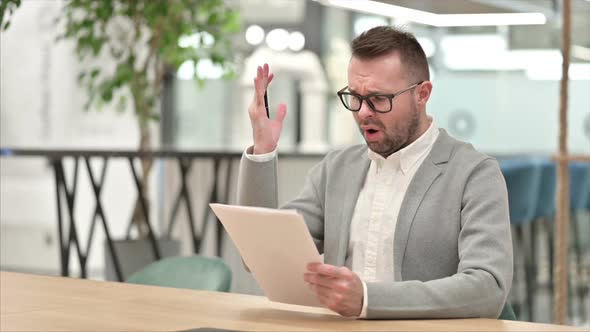 Creative Man Upset By Reading Documents alt