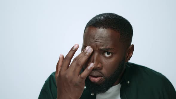 Portrait of Attractive African American Man Checking Beard Look in Studio alt