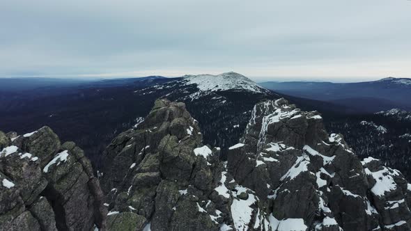 Aerial view of mountain range in winter day, drone moves forward
