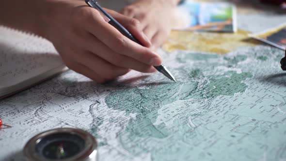A Traveler Girl Shows A Point On The Map Where A Travel Is Planned, Travel Planning Is An Adventure alt