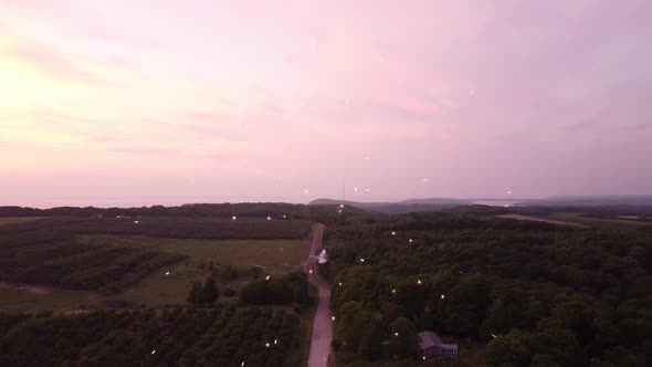 Fireworks Exploding In Sky At The Farm Country By The Road In Leelanau County, Michigan. - Wide Shot alt