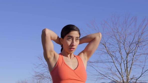Young fit woman fixing hair before outdoor run alt