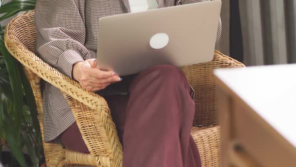 Happy Businesswoman Sitting in Business Center with Laptop and Smartphone alt