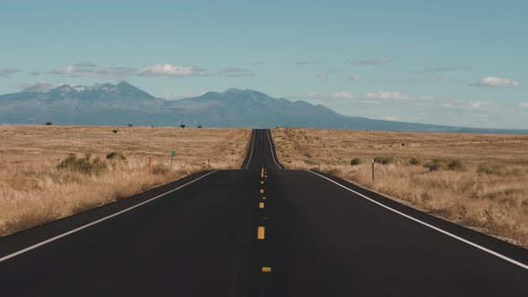 Driving On Road Going Into Distance Through Desert On Background Of ...