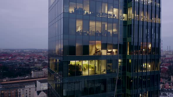 Modern Skyscraper with Glass Surface Late at Night alt