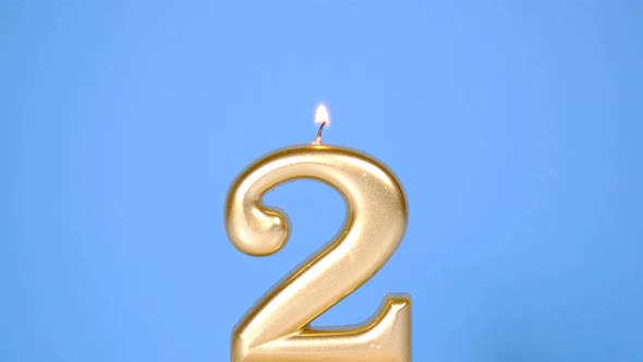 Anniversary Video Banner with Burning Golden Number Two Candle on Blue Background