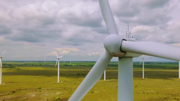 Wind Turbine Farm Generating Clean Renewable Energy In Green Agricultural Field Aerial Landscape