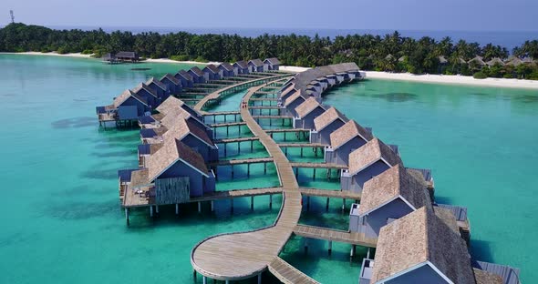 Daytime birds eye tourism shot of a white sand paradise beach and blue water background in vibrant 4 alt