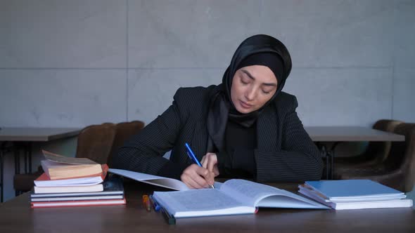 Young Muslim Woman in Hijab Studying and Preparing for Exams