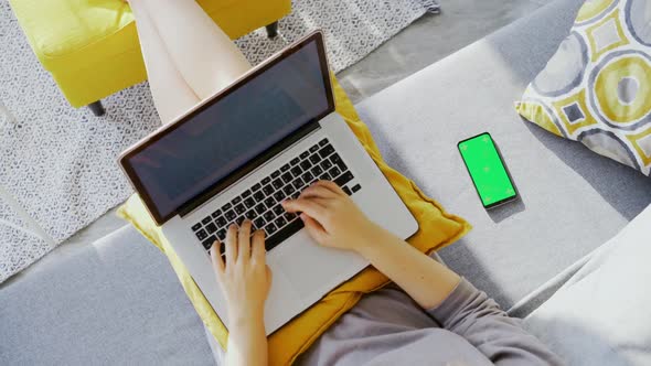 Flat Lay Woman Working on Laptop Sitting on Couch